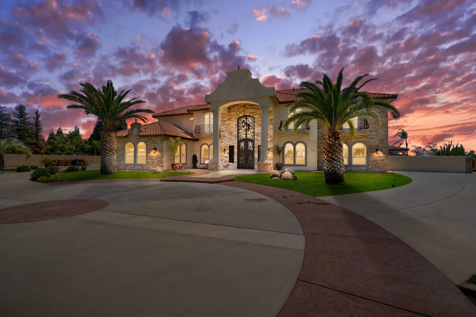 A luxury stone estate at twilight - Flyover Creative real estate media